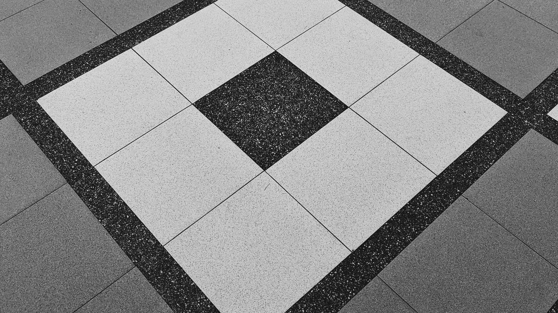 Professional installer applying pre-mixed grout to a mosaic kitchen backsplash tile installation in Central Florida