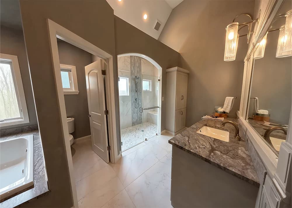 Tan stone-look porcelain bathroom remodel installation in Winter Garden, FL by Aesthetic Tile