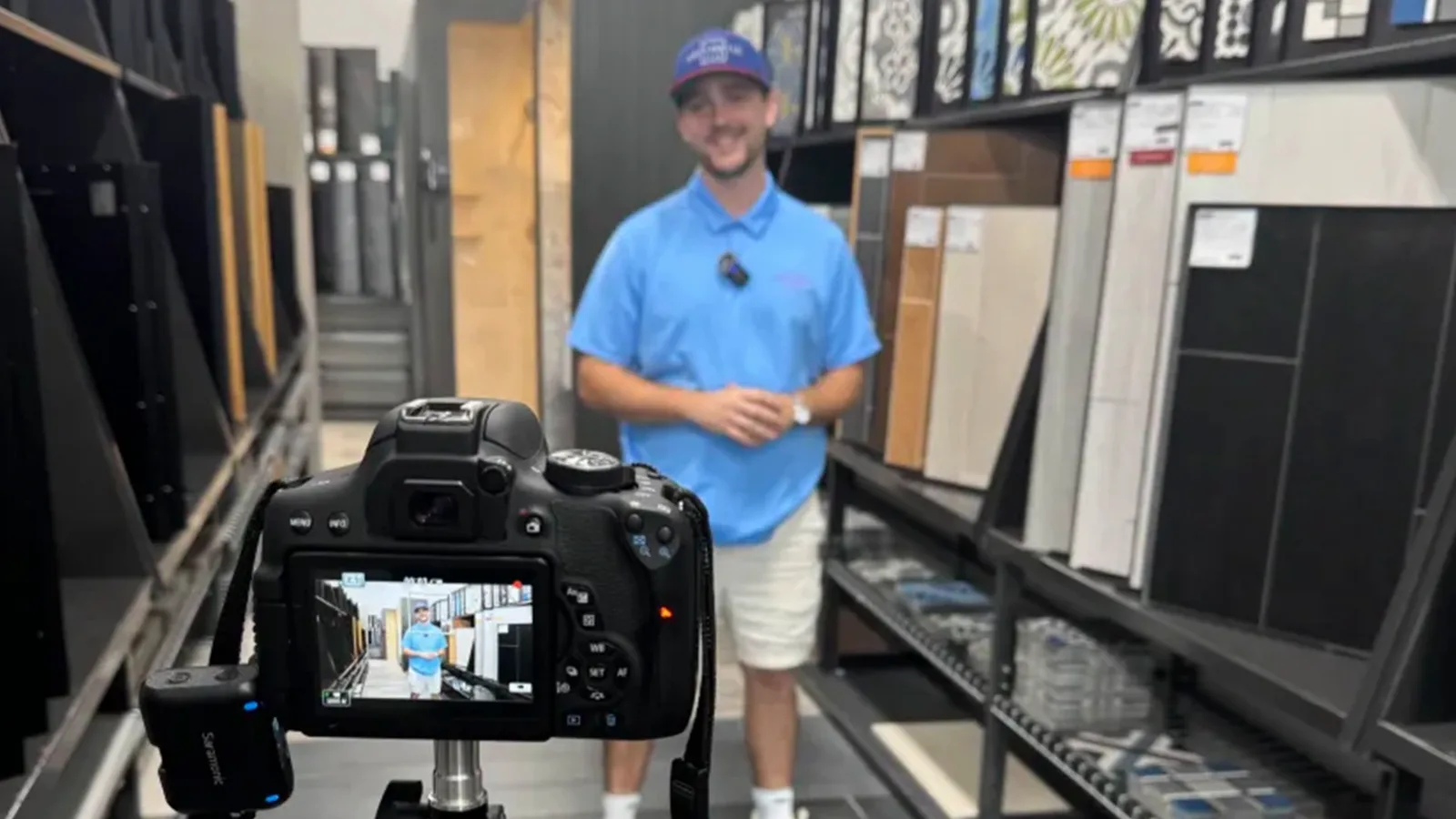 A camera on a tripod records Brad Fleitz of Aesthetic Tile in a tile aisle at The Tile Shop in Orlando