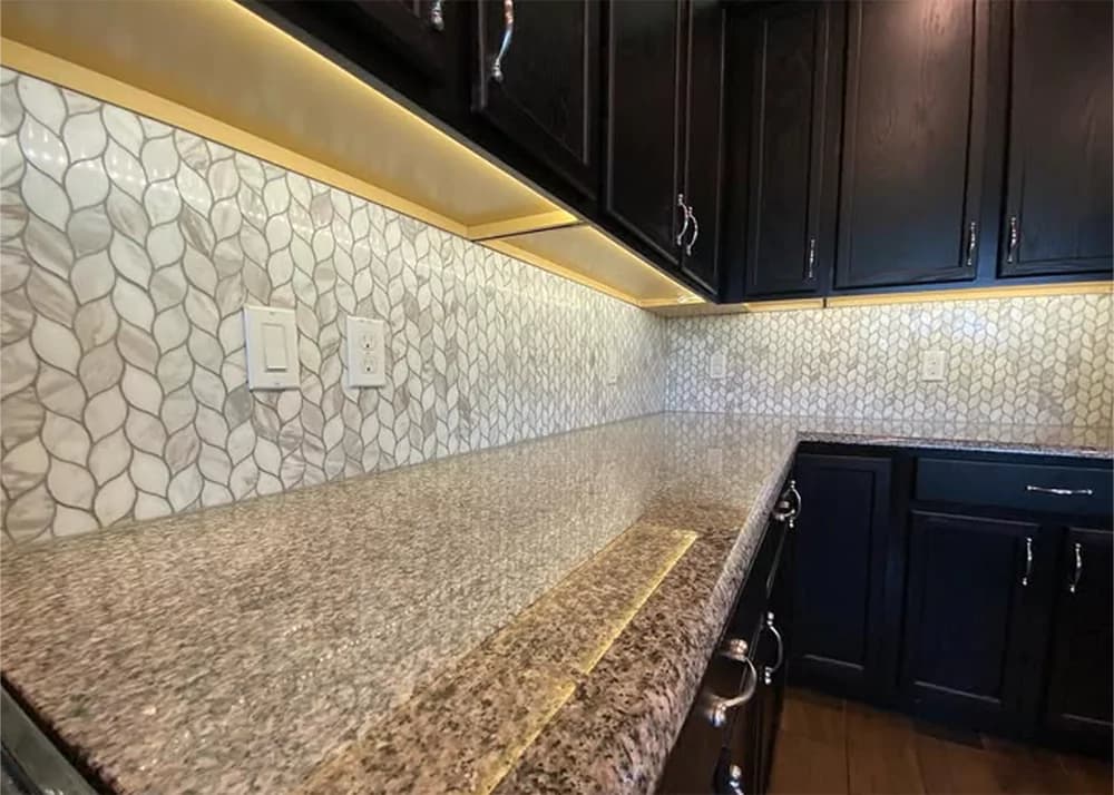 Natural stone mosaic kitchen backsplash tile installation in Groveland, FL home by Aesthetic Tile