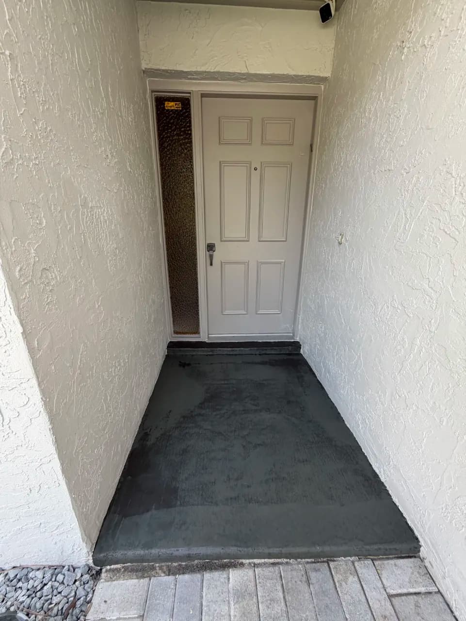 Dark prepared porch base before tile setting