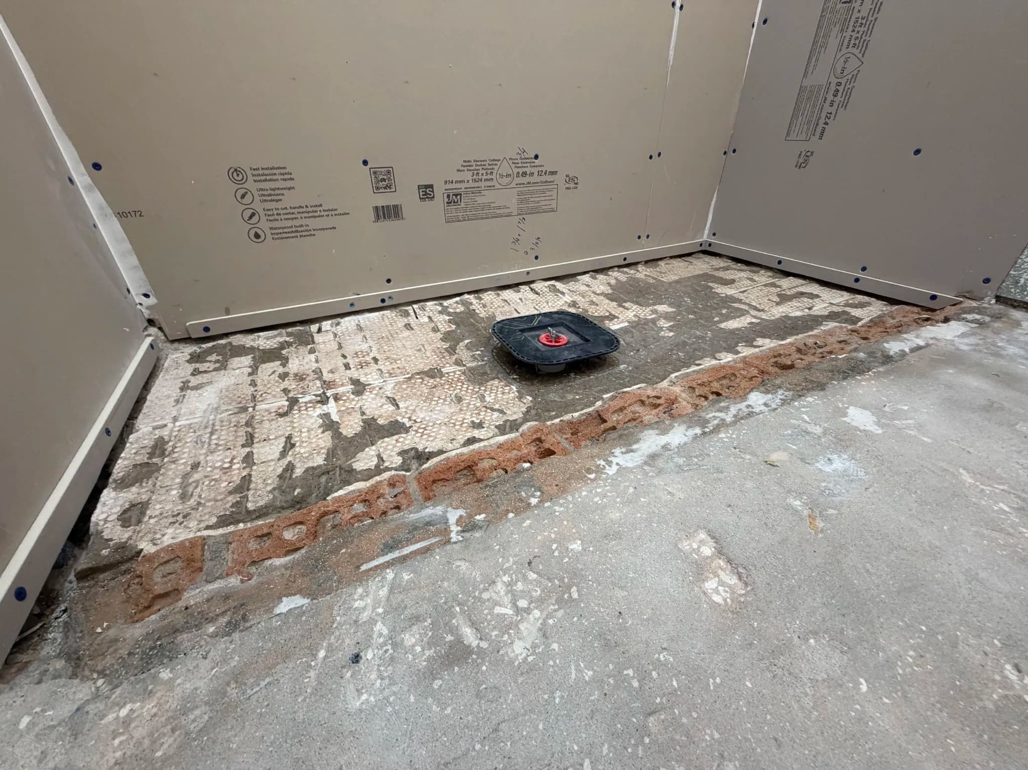 Shower entrance after removal of the old brick curb