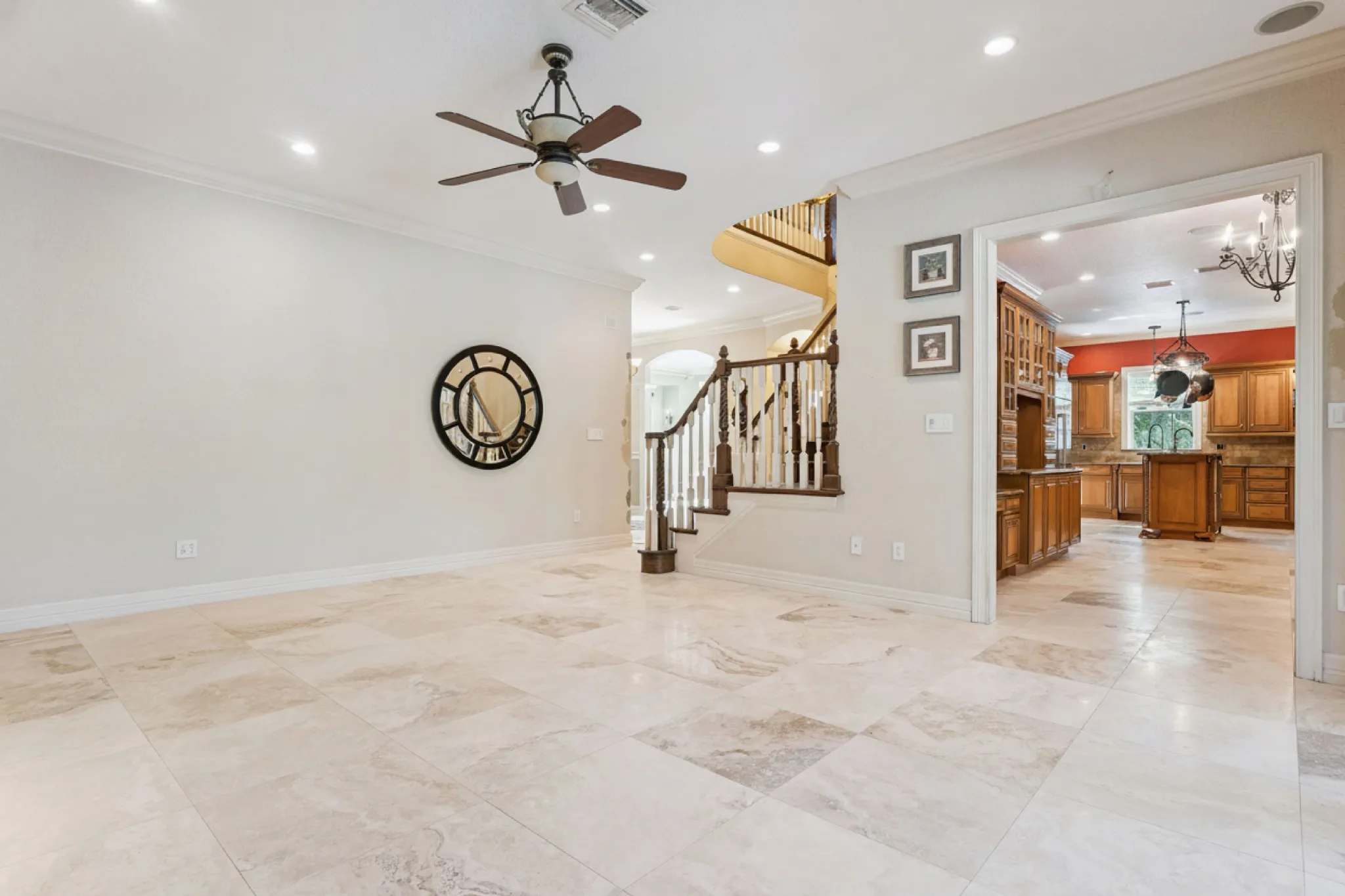 Light marble flooring continuing through a living area and into the kitchen