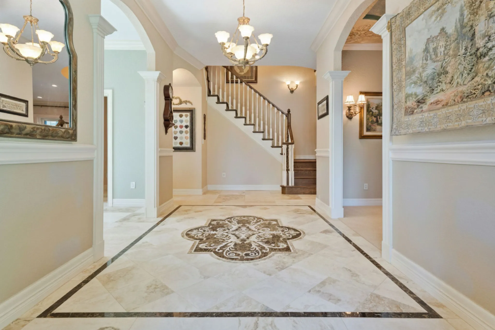 Marble foyer with a central medallion and bordered diagonal inlay