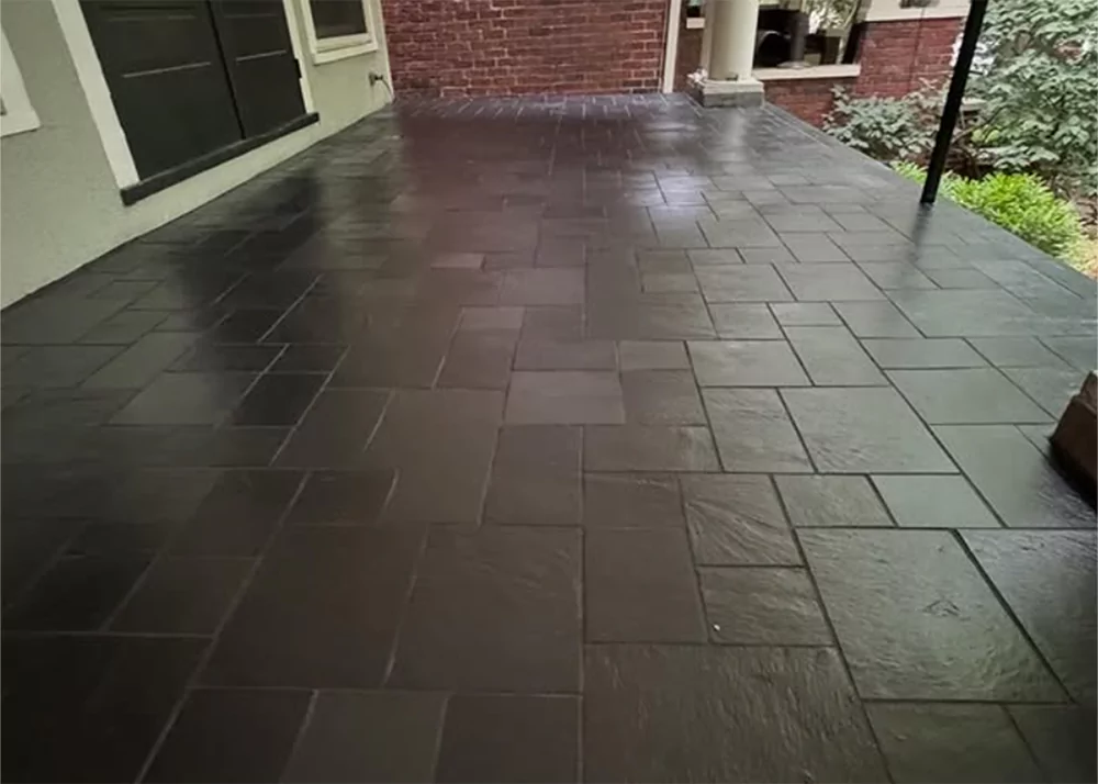 Porcelain outdoor patio tile installation with brick exterior in Central Florida home by Aesthetic Tile
